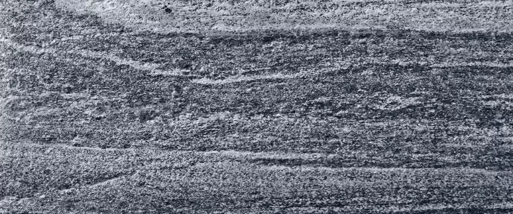 Migmatitic gneiss migmatite rock bands pattern grey light dark banded granite texture macro closeup textured silver gray horizontal background coarse grained feldspar quartz mica minerals gneissic