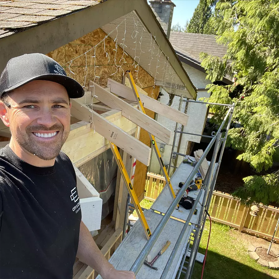 Owner Shayne smiling with house building in progress