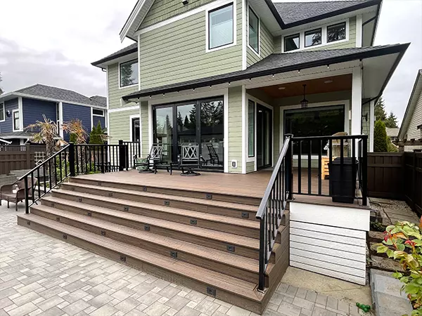 Large composite deck with stairs and large black deck doors