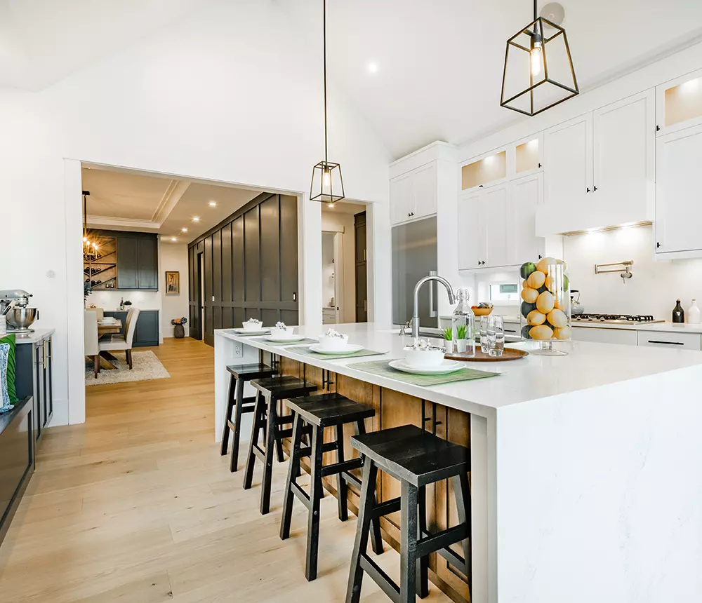 Home renovation with open-space kitchen and living room, white cabinets with black and gold accents in Metro Vancouver