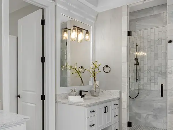 Traditional classic bathroom remodel with lights over an elegant mirror