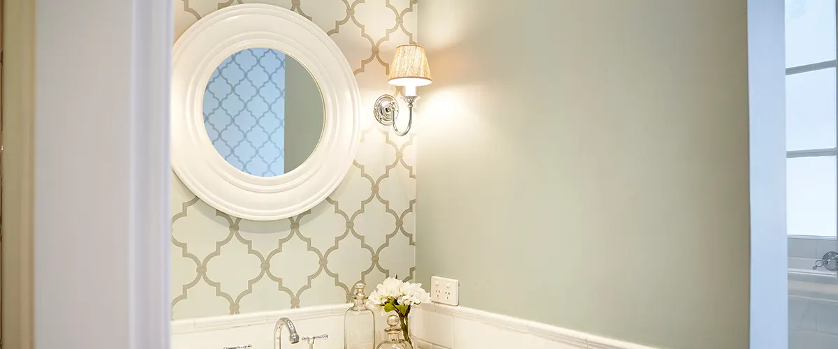 Small hallway bathroom with elegant task lighting on the sides of the mirror