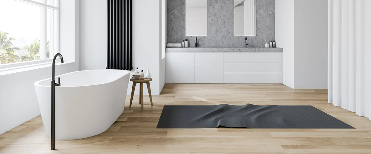 A large bathroom with a white tub and wood flooring for a bathroom renovation cost in langley