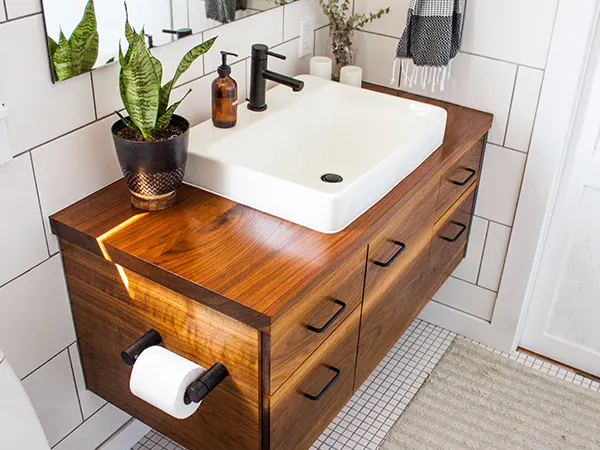 A modern wood vanity with a porcelain sink