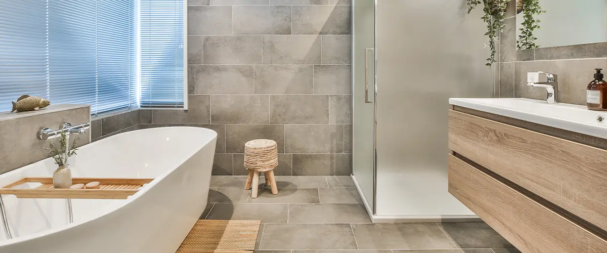 Bathroom with large tile flooring and tub