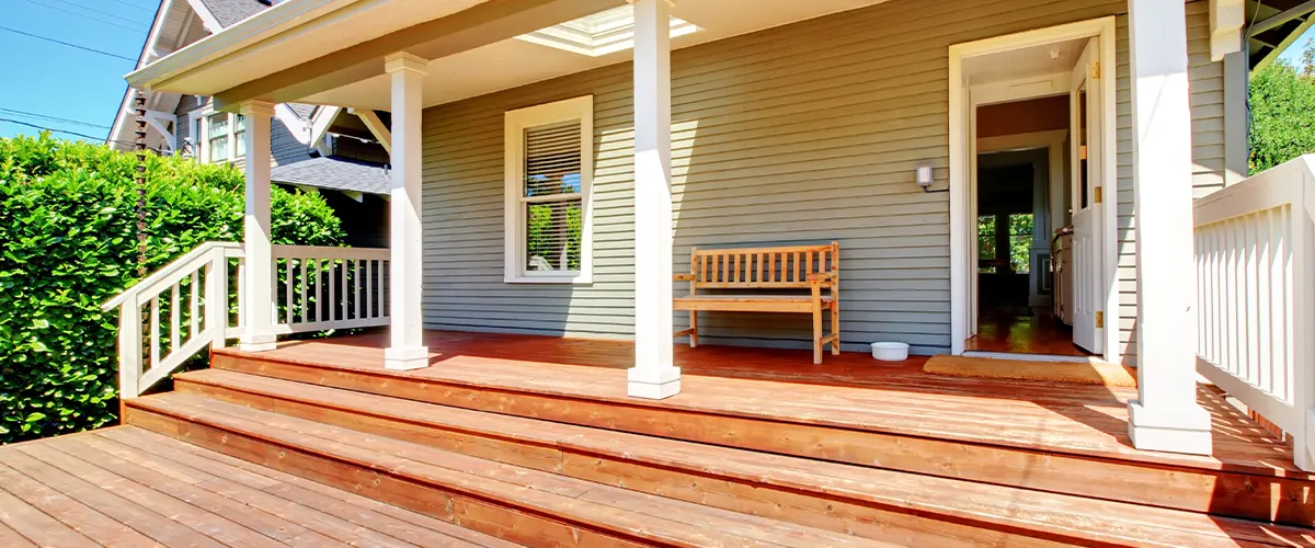 Deck attached to a porch with stairs