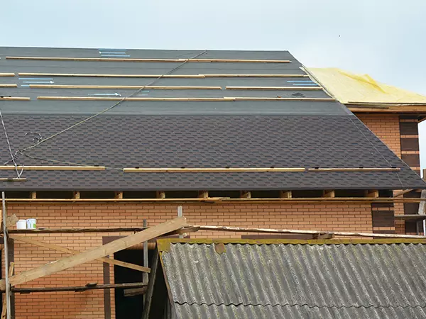 Asphalt shingles roofing construction. Asphalt shingles installation on the roofing underlayment