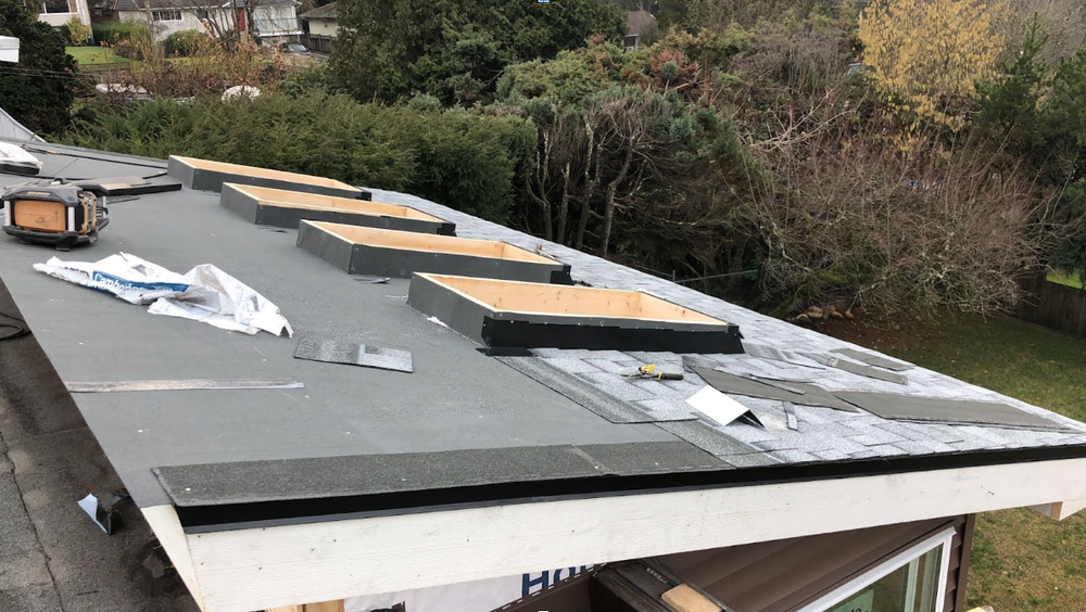 Roof under renovation with exposed areas and roofing materials, emphasizing winter preparation and holiday decor safety for homeowners.